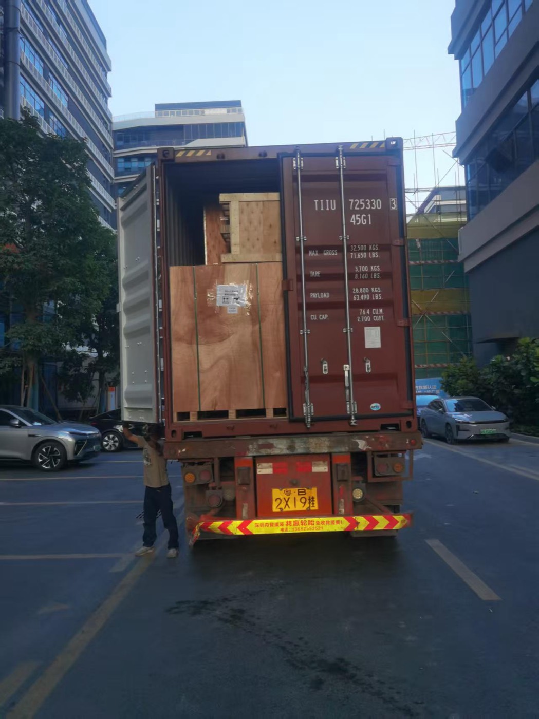 Forklift loading a container on a city street