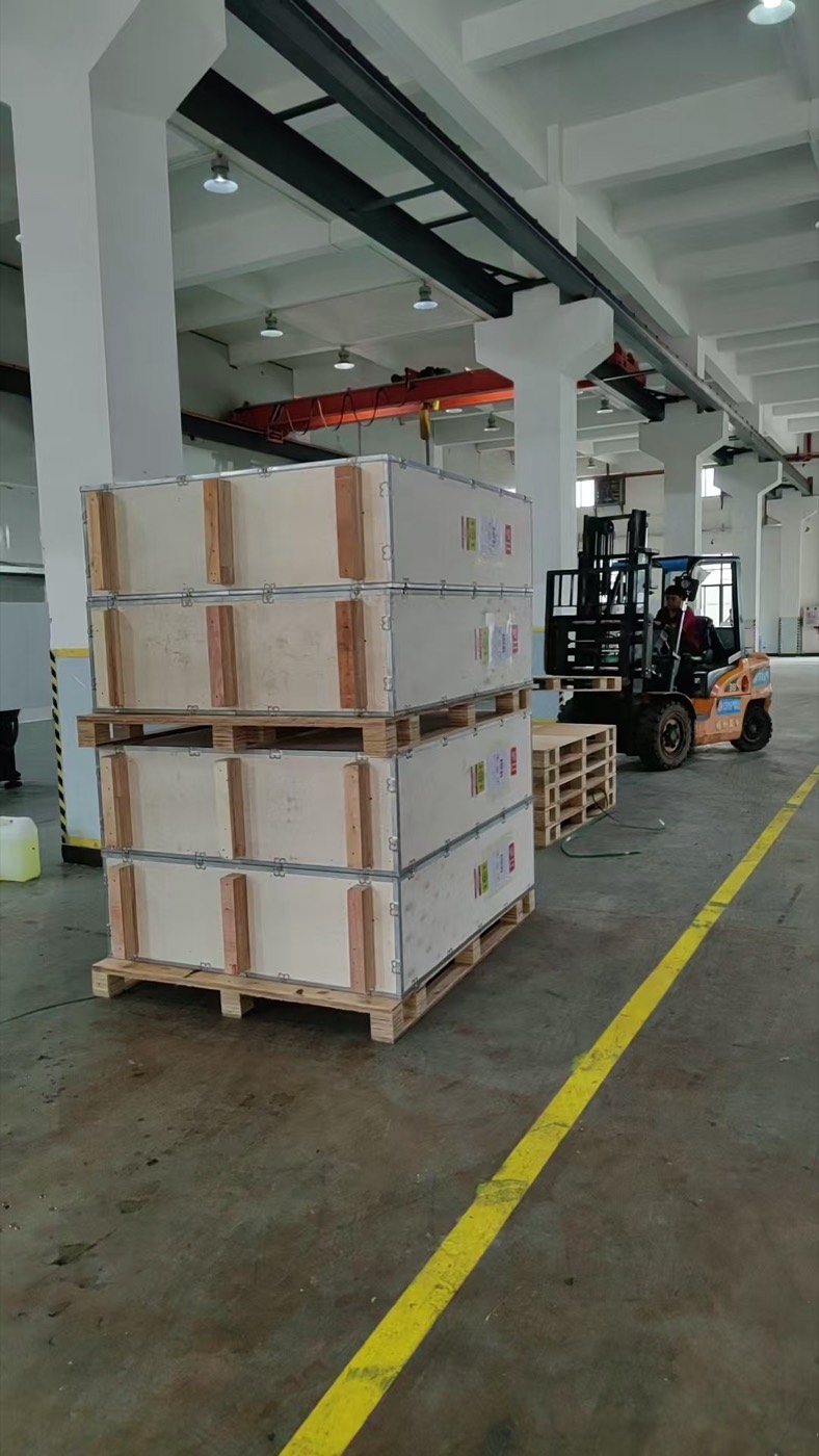 Forklift moving palletised goods in a warehouse